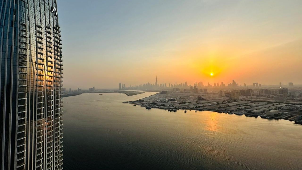 Dubai Creek Harbour waterfront at sunset with the Downtown Dubai skyline in the distance
